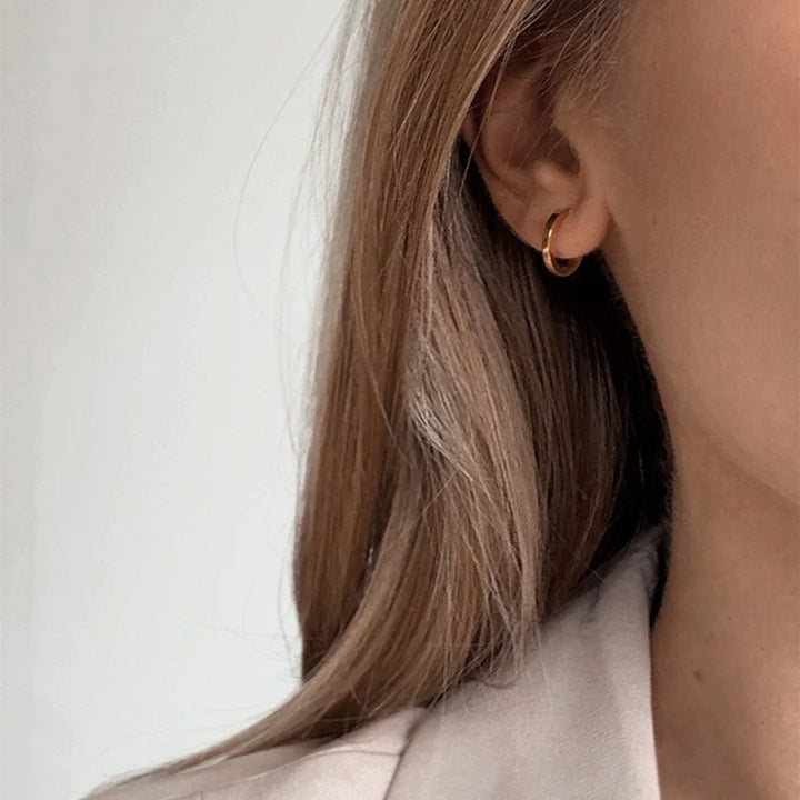 huggie hoop earrings made in waterproof 14k gold plated steel from icône 
